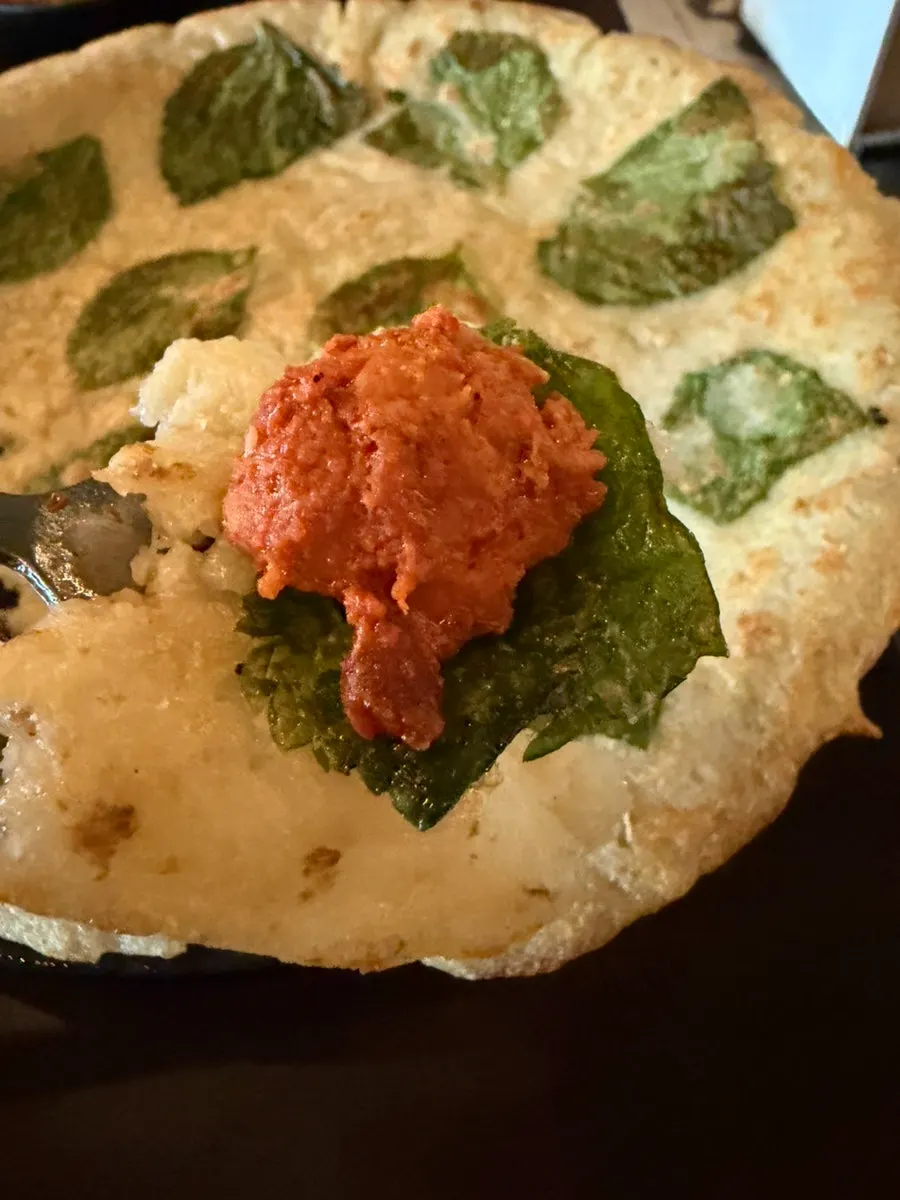 깻잎감자전 위에 닭갈비를 올려 싸 먹는 모습