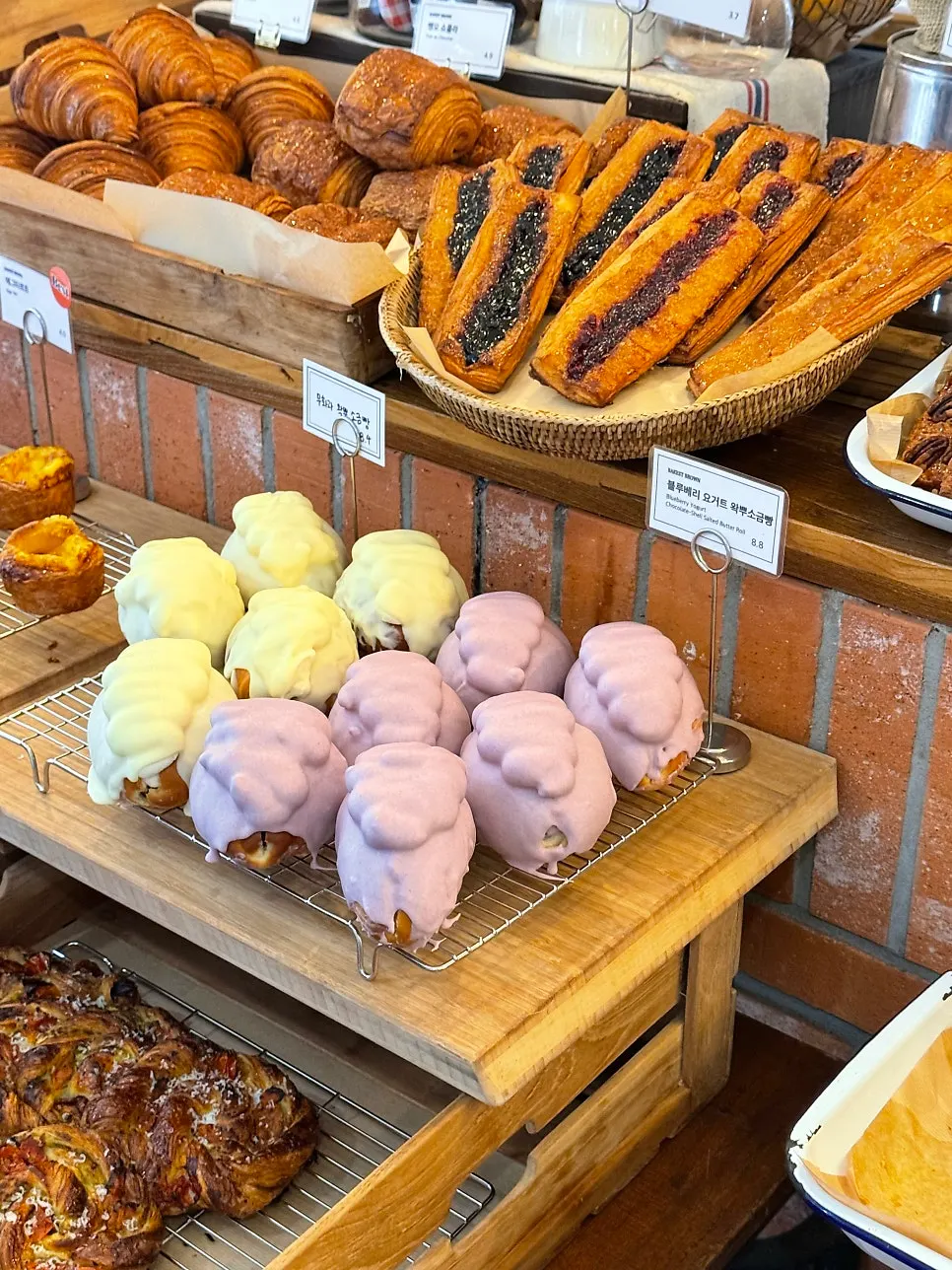 1st floor bakery counter filled with a variety of breads