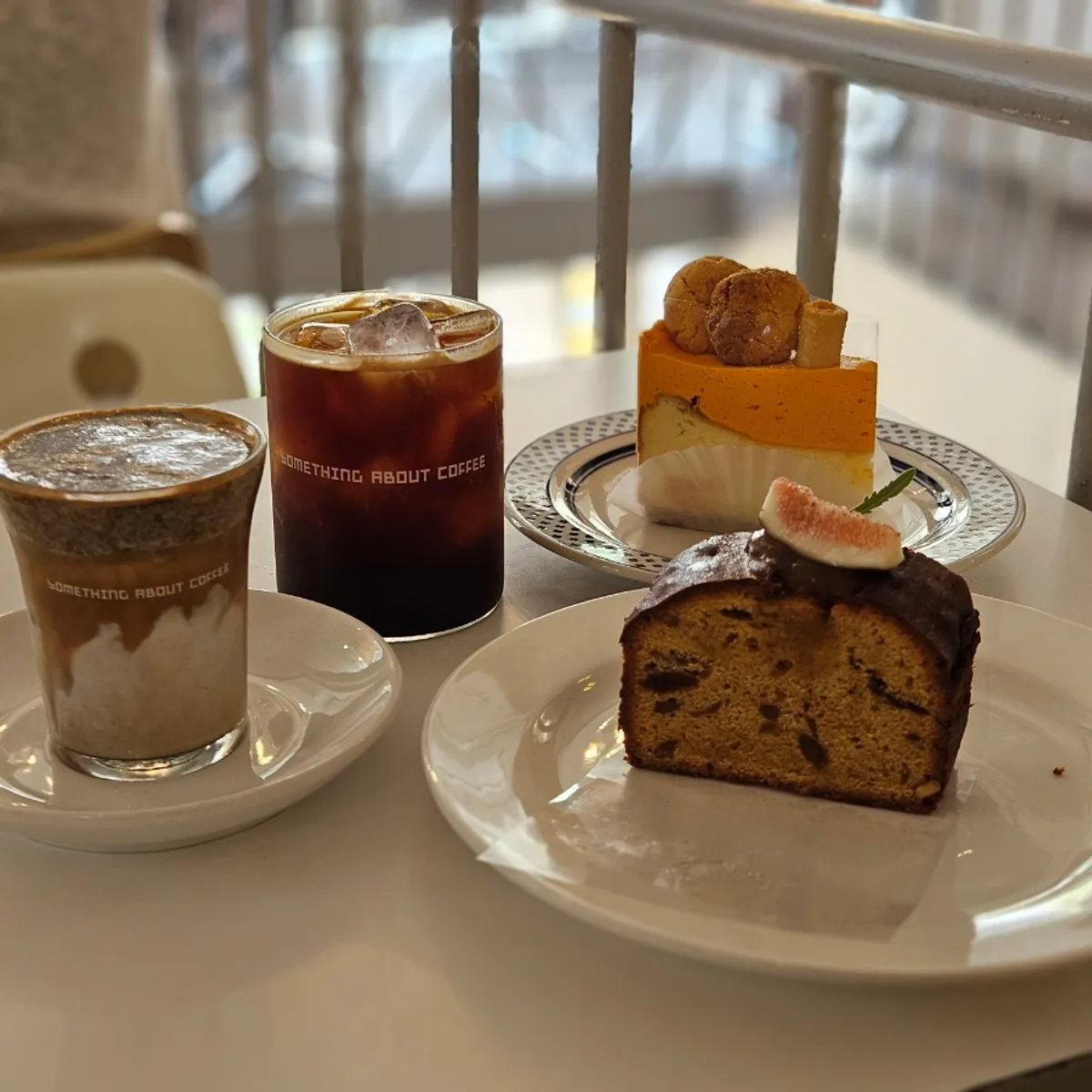 Four drinks and desserts arranged on a table