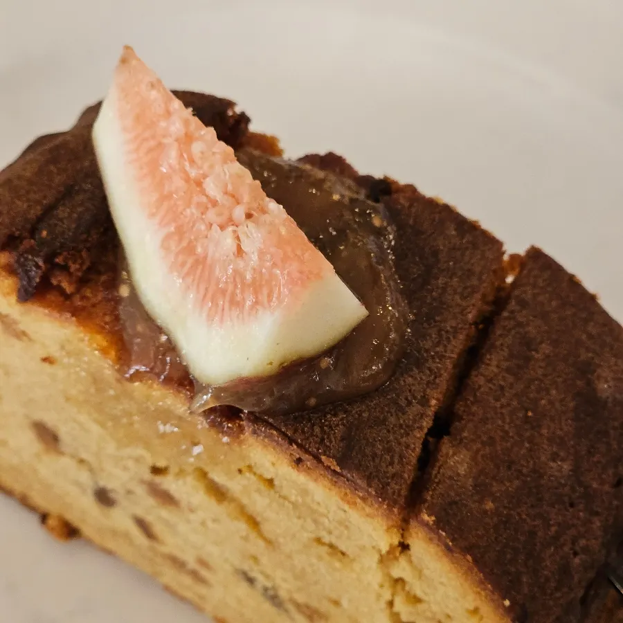Cross-section of pound cake studded with fig and nuts