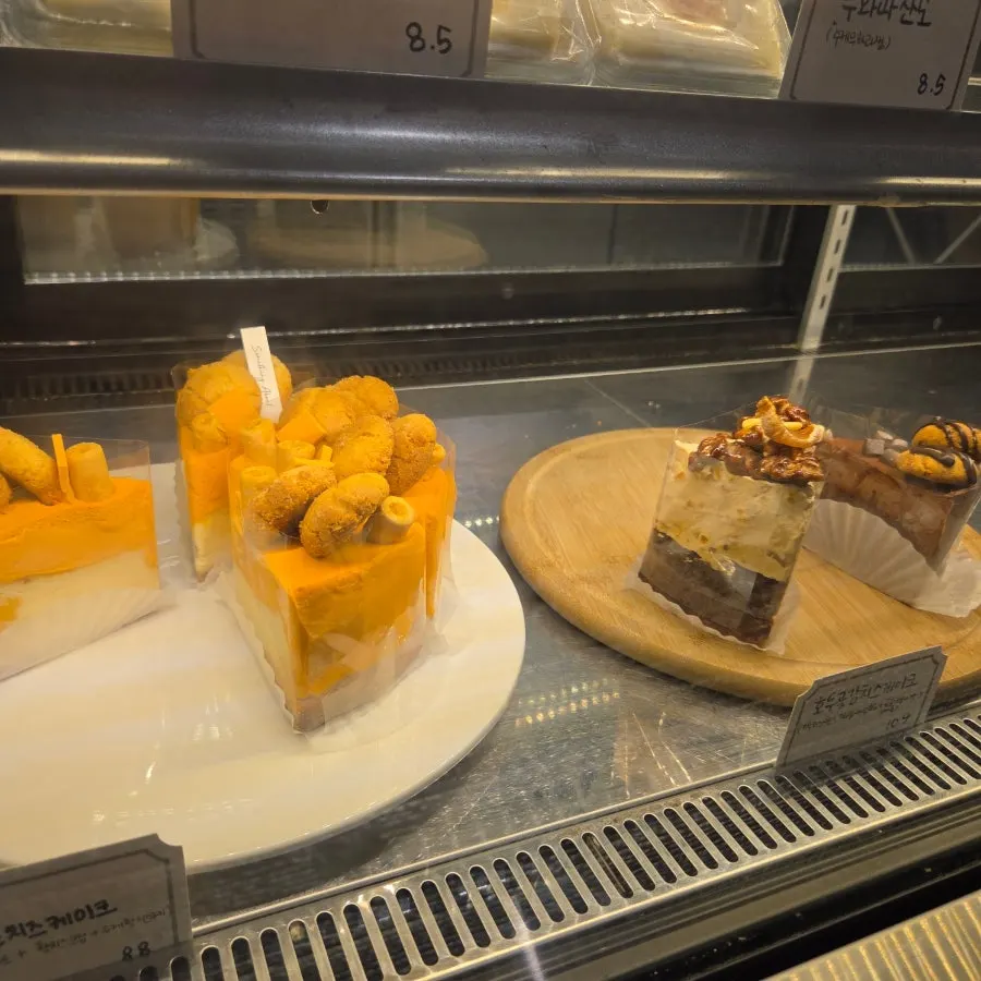 Display case with cakes and sourdough loaves