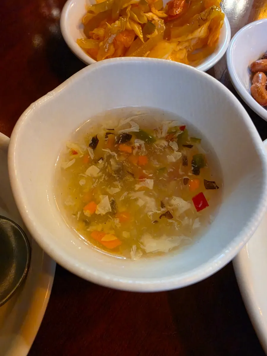 Egg drop soup served alongside the eggplant rice bowl