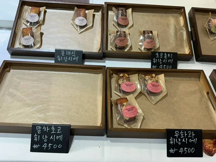 Display case of financiers, madeleines and other baked goods
