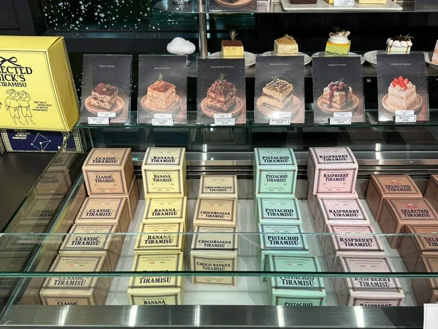 Display case showing 9 tiramisu flavors