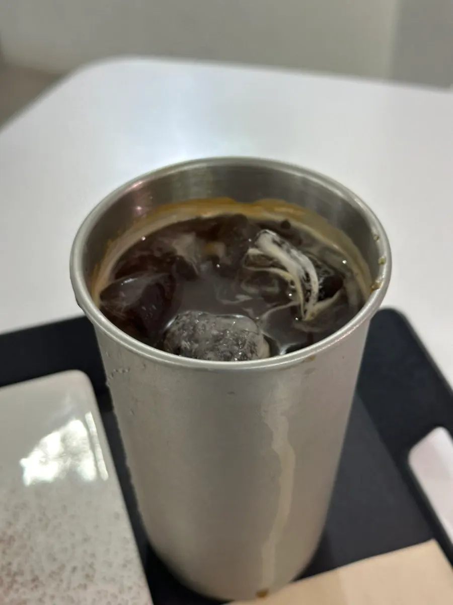 Decaf iced americano next to the half-eaten du-jjon-ti