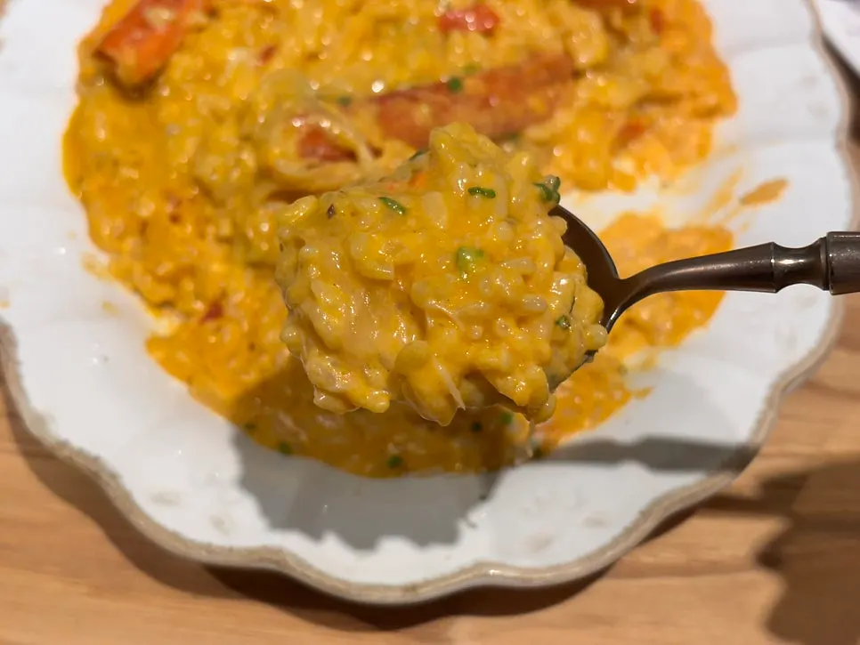 Spoonful of spicy crab risotto lifted from the plate