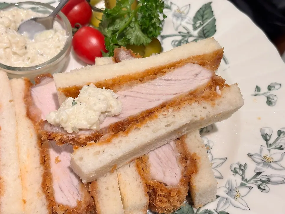 Cross-section of katsu sando topped with onion sauce