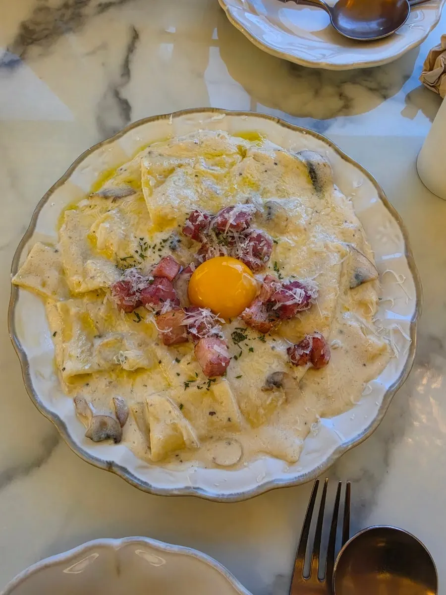 Flat carbonara served with egg yolk