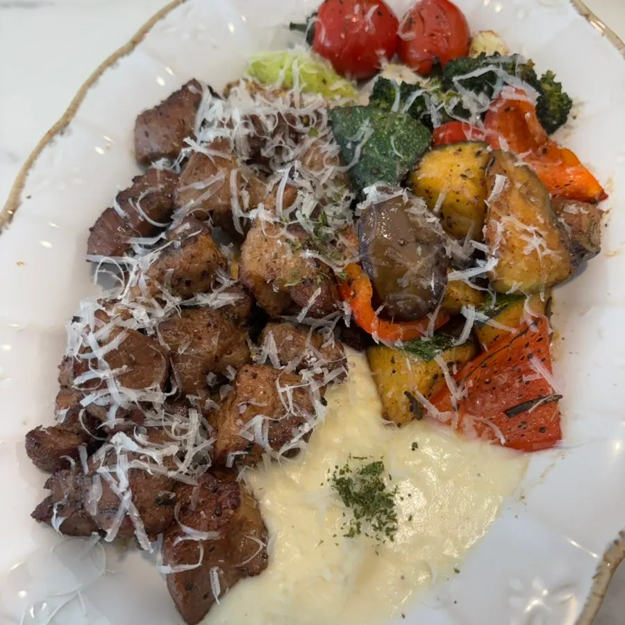 Chopped pork neck steak served with vegetables