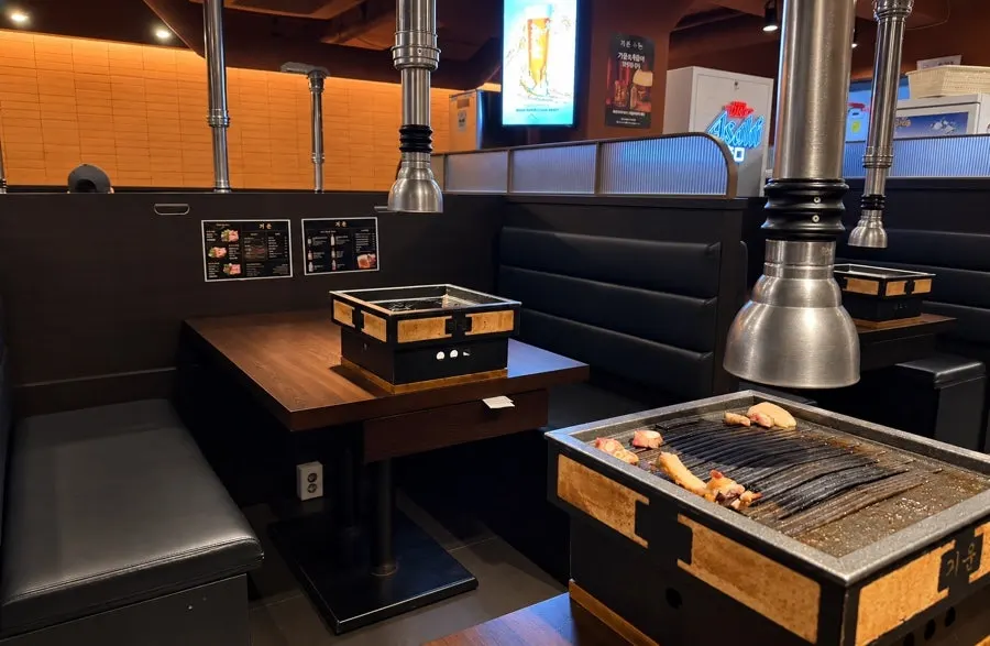 Interior seating with wood-tone decor and partitioned tables