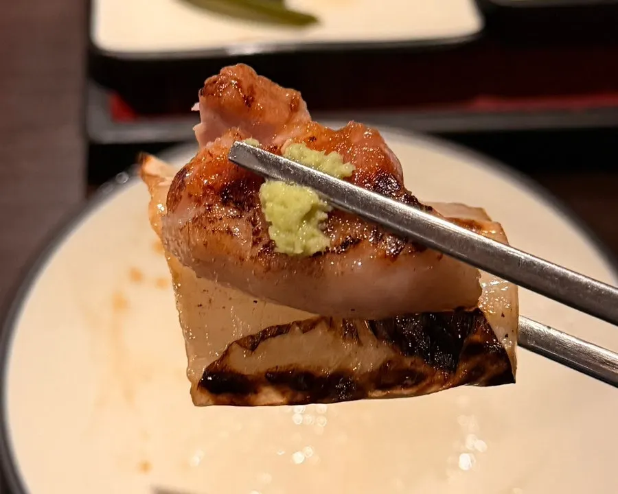 A piece of galbi samgyeopsal topped with wasabi