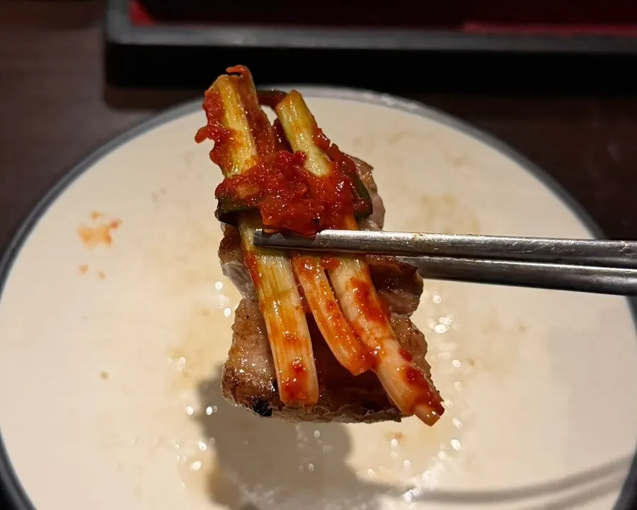 Galbi samgyeopsal topped with green onion kimchi and chive salad