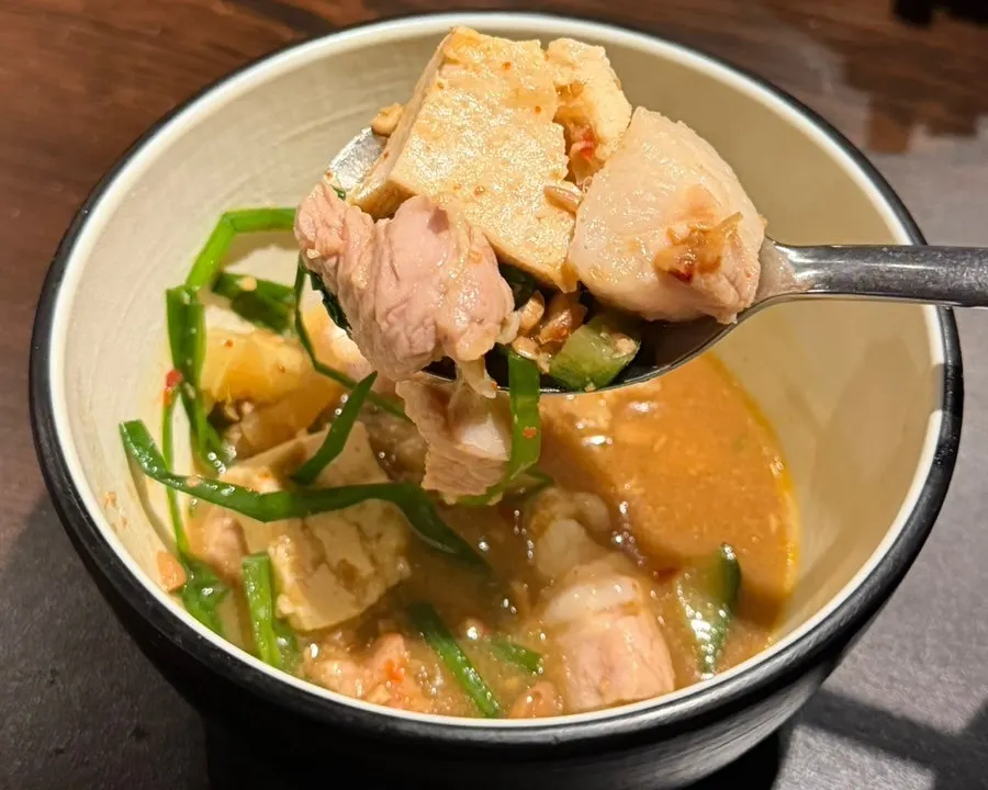 Inside the doenjang jjigae with tofu, meat and chives