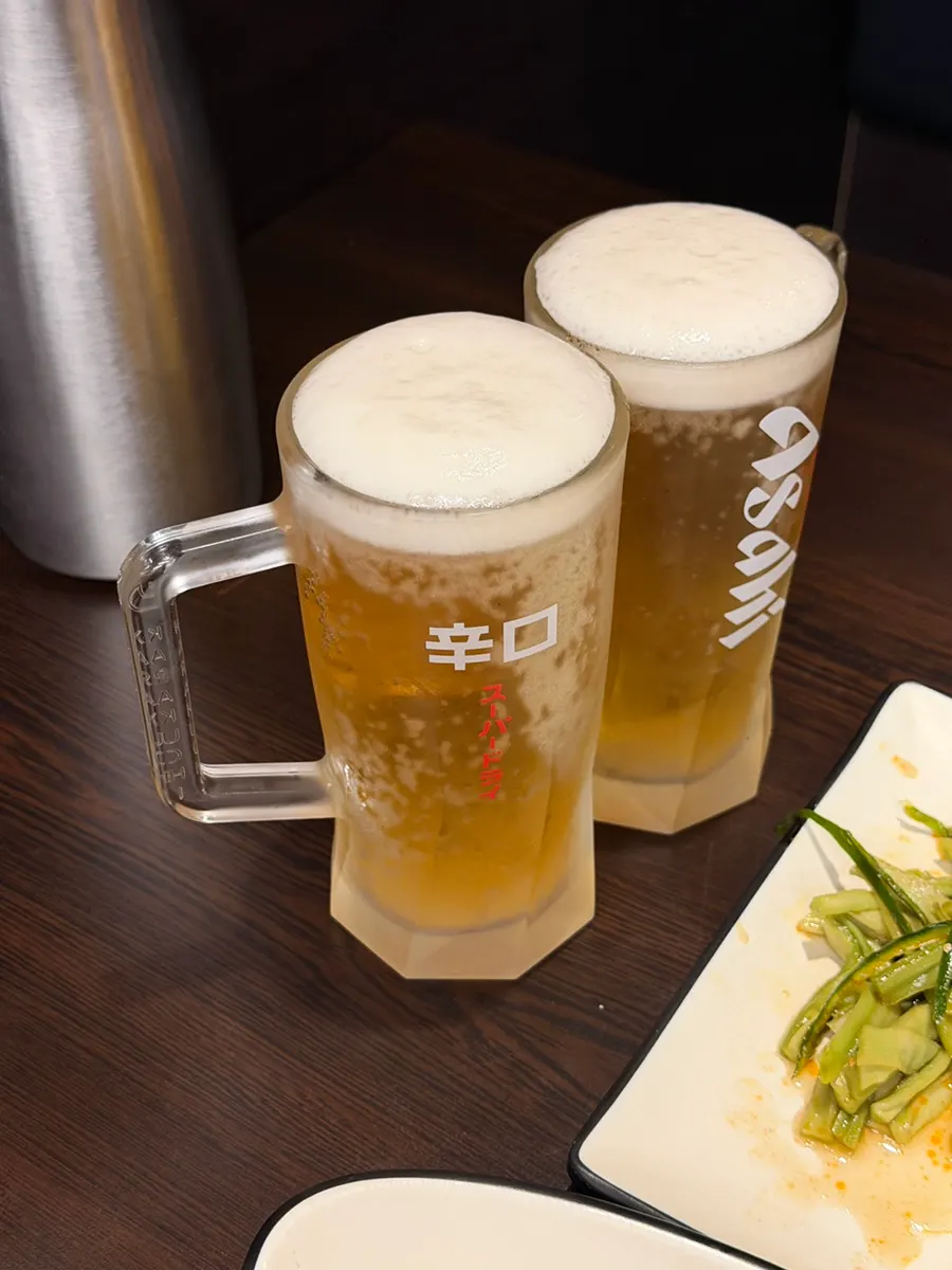 A glass of Asahi draft beer ordered at the table