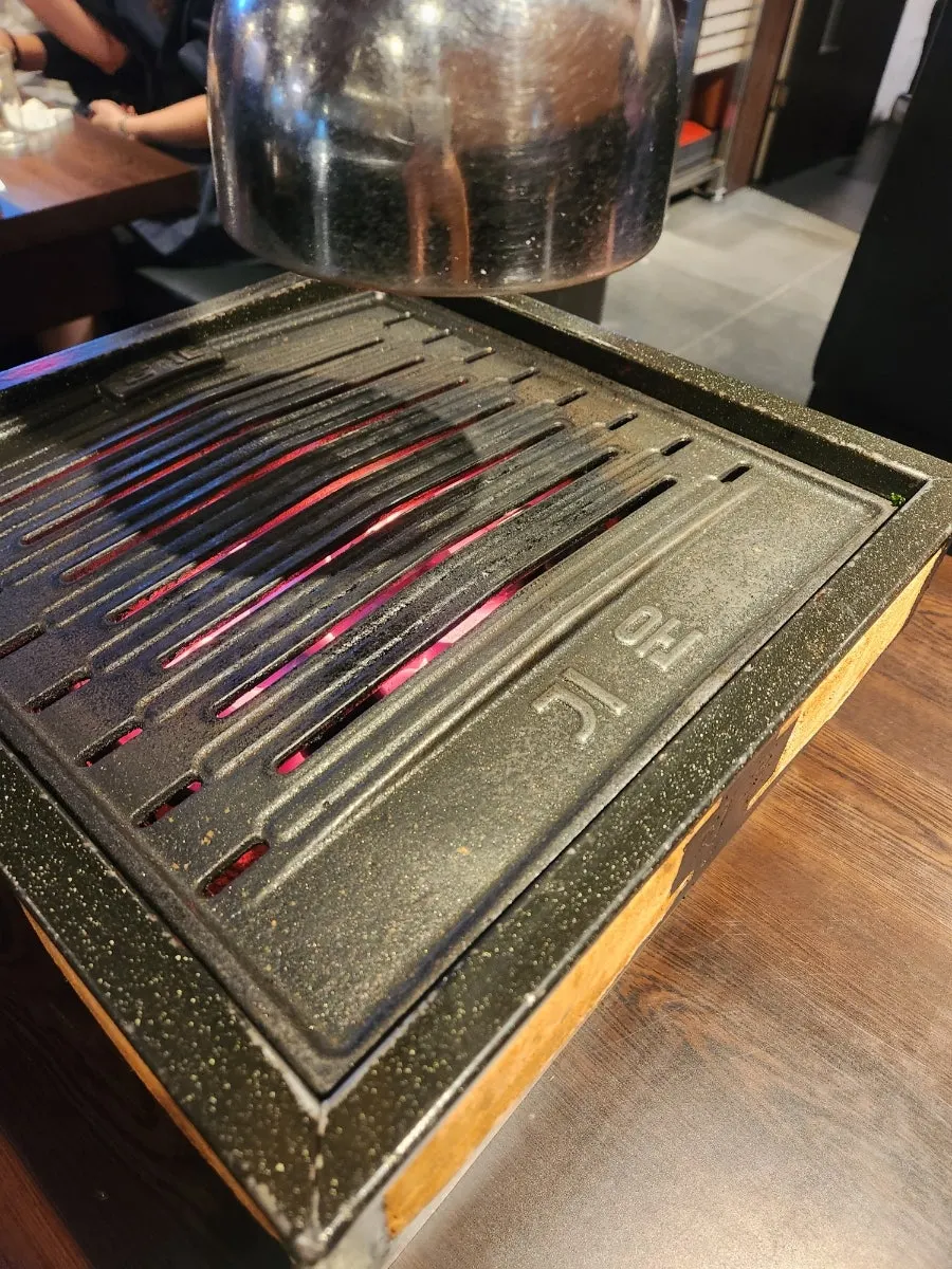 Tabletop charcoal grill with charcoal added