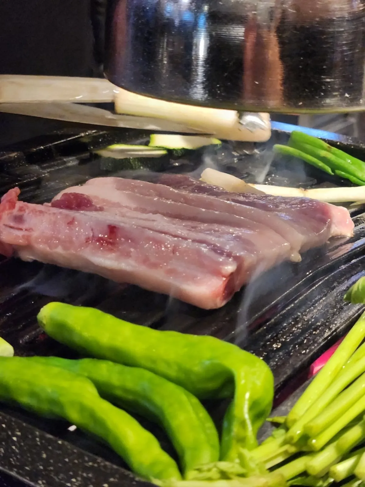 Galbisamgyeop grilling over charcoal