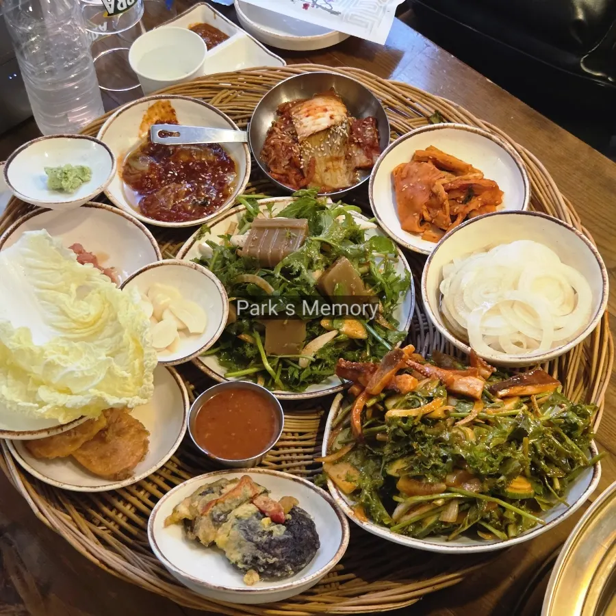 Generous basic banchan spread including squid and acorn jelly salad