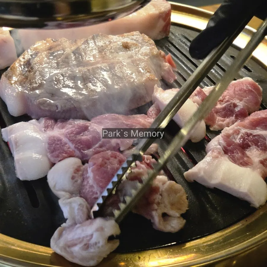 Raw plate of aged whole pork belly, aged whole pork neck, and kkodeulsal