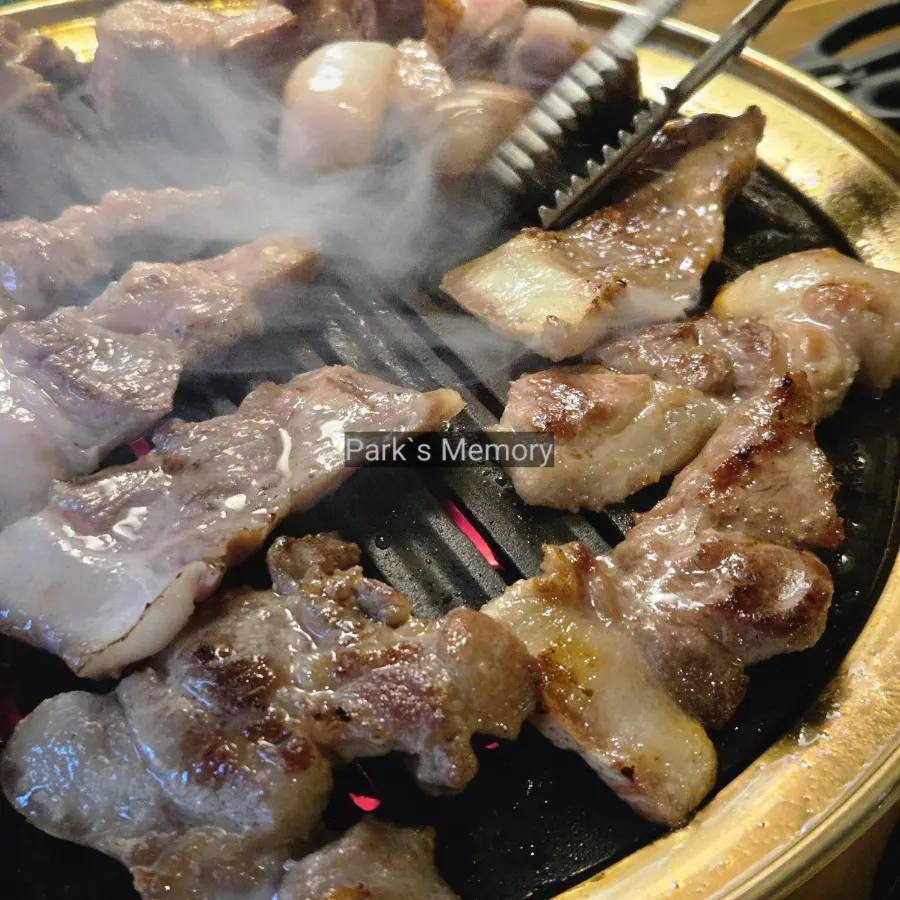 Pork belly and pork neck grilling over charcoal