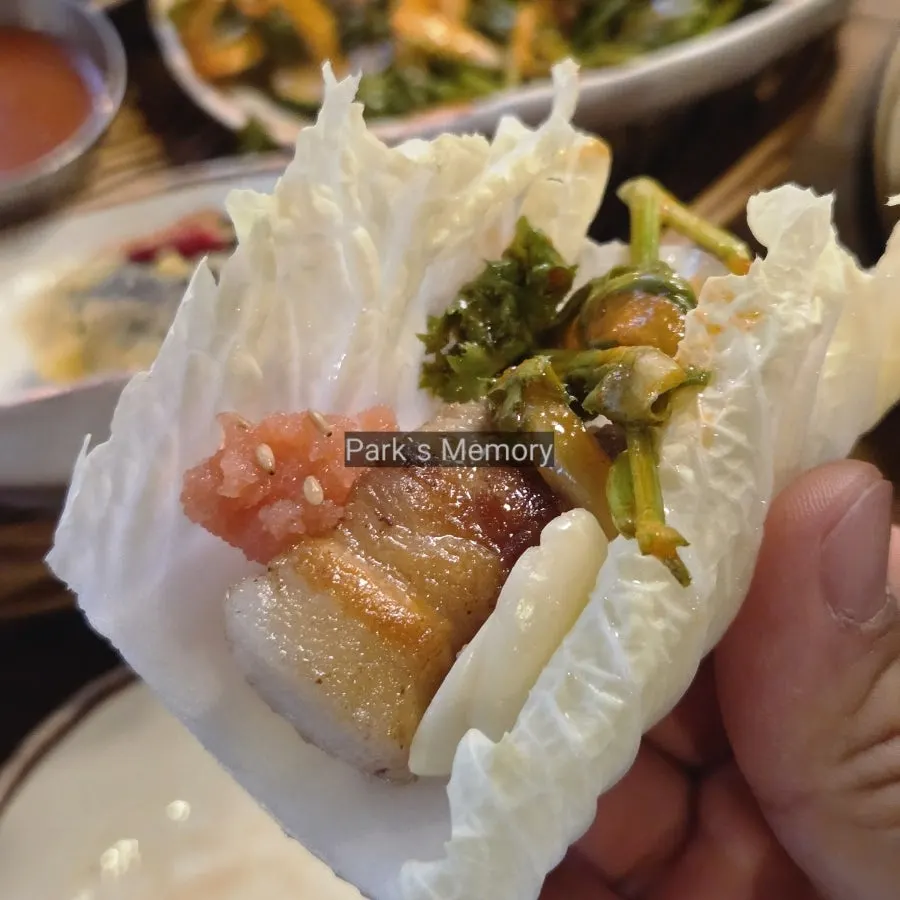 Fully grilled meat served alongside young napa cabbage