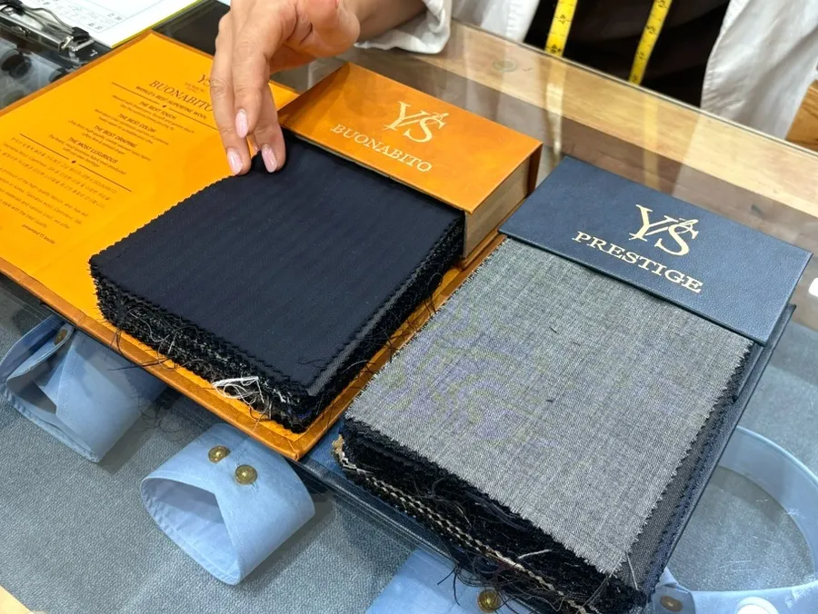 Fabric consultation in progress for a custom suit