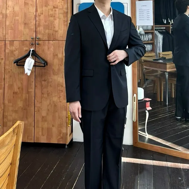 Wearing the finished dark grey suit with a classic fit
