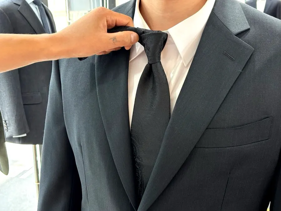 Full-body shot of the suit with a subtle sheen