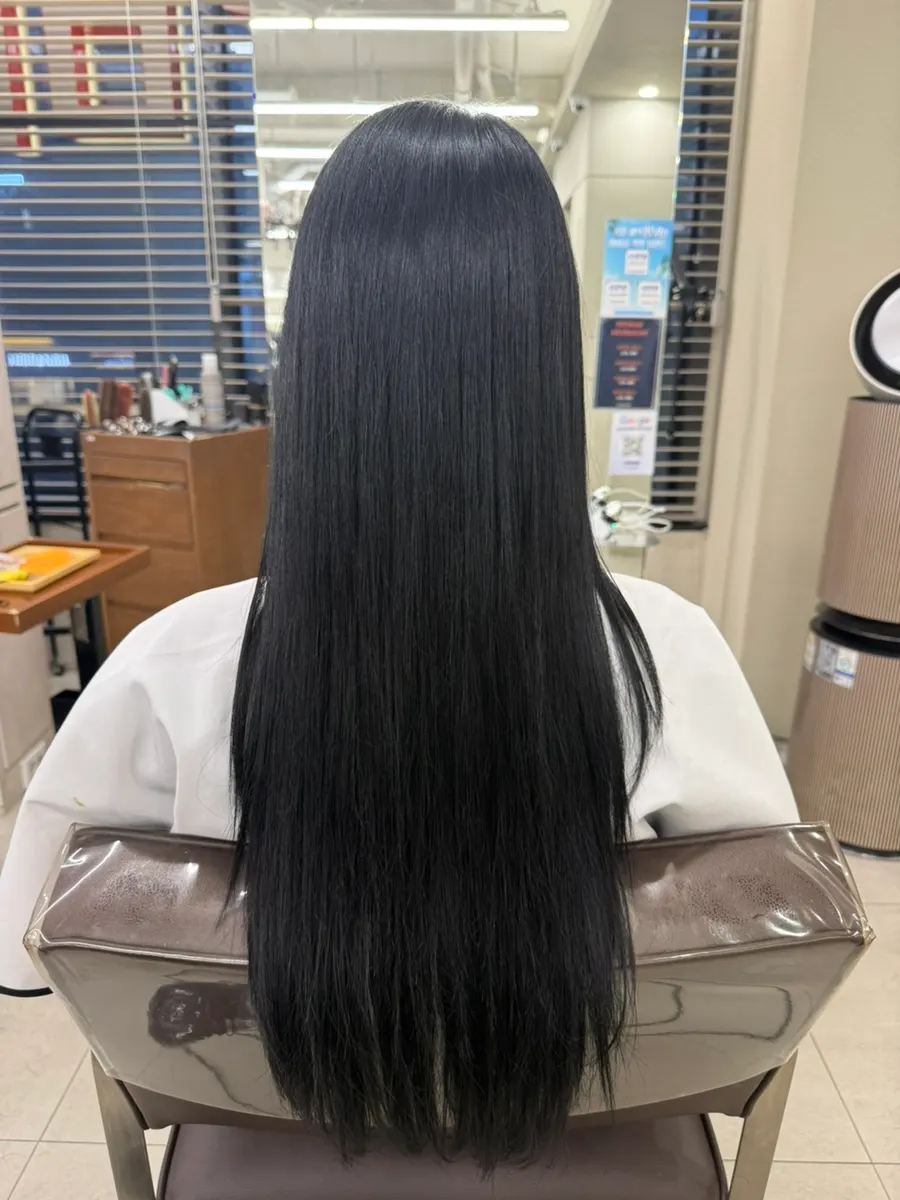 Black hair reflected in the mirror after the service