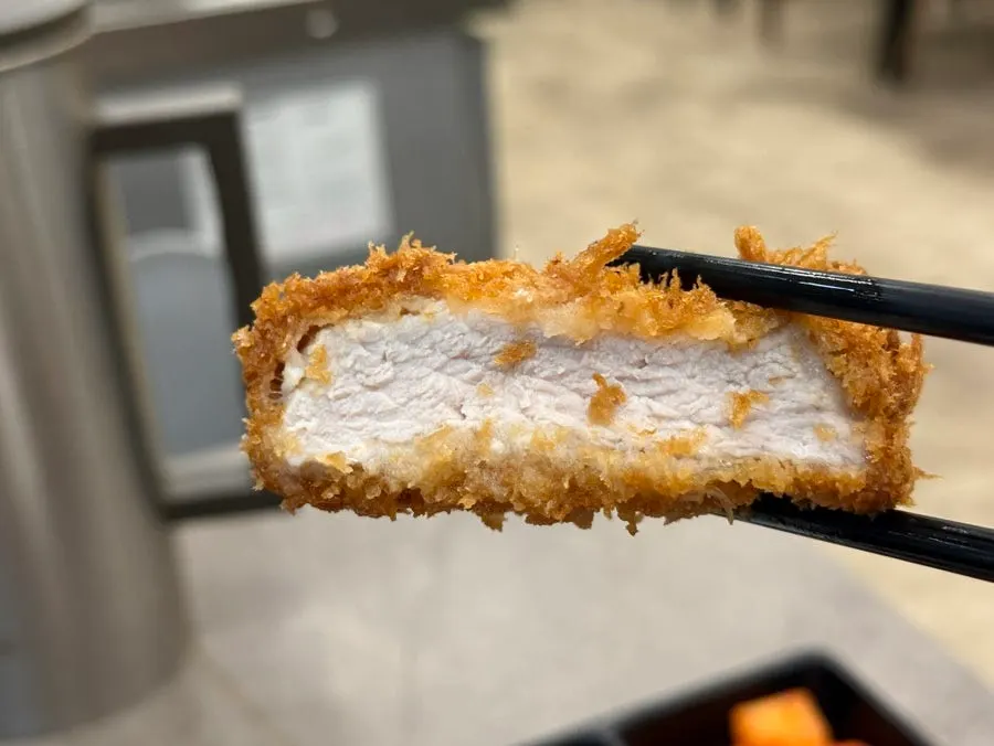 Cross-section of the pork cutlet showing a thick cut of meat