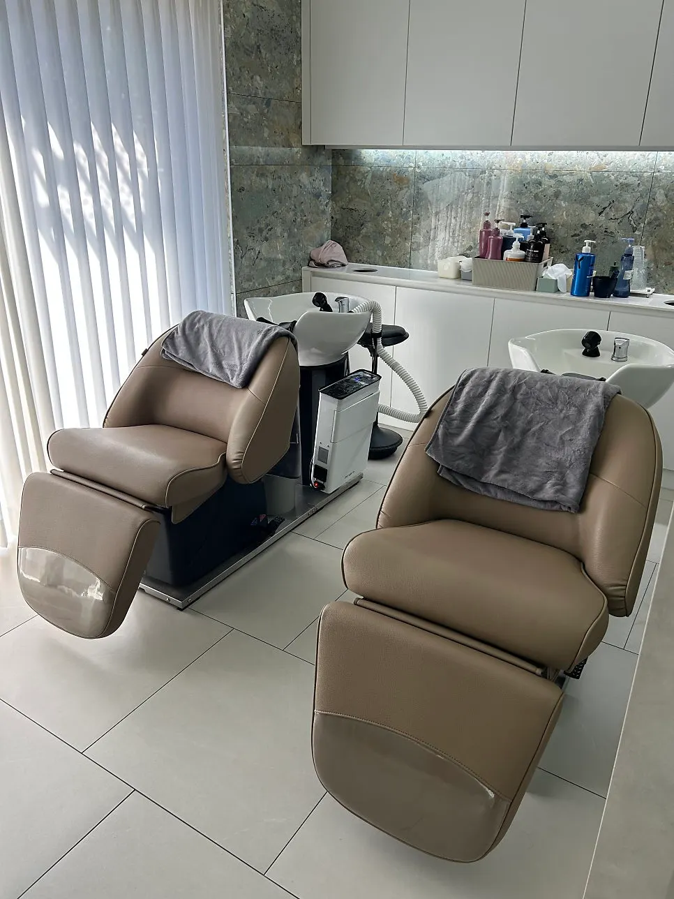 Neatly arranged salon seats and mirrors