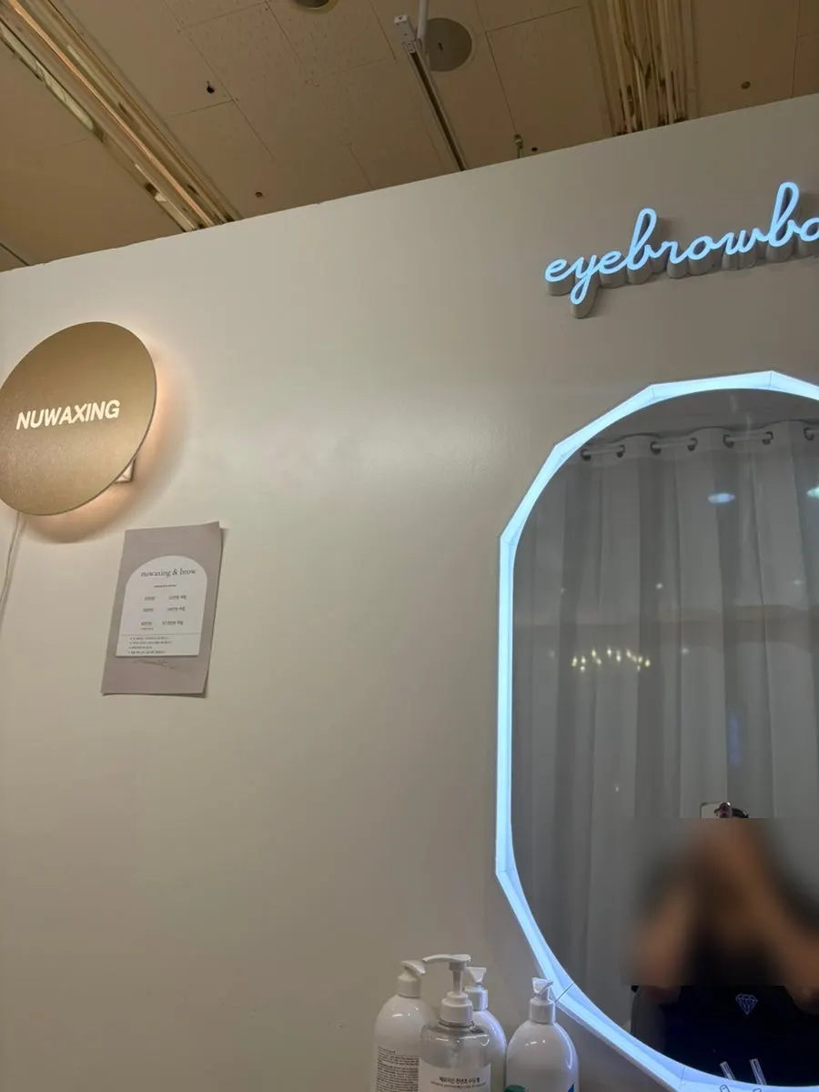 Waxing treatment area with a mirror