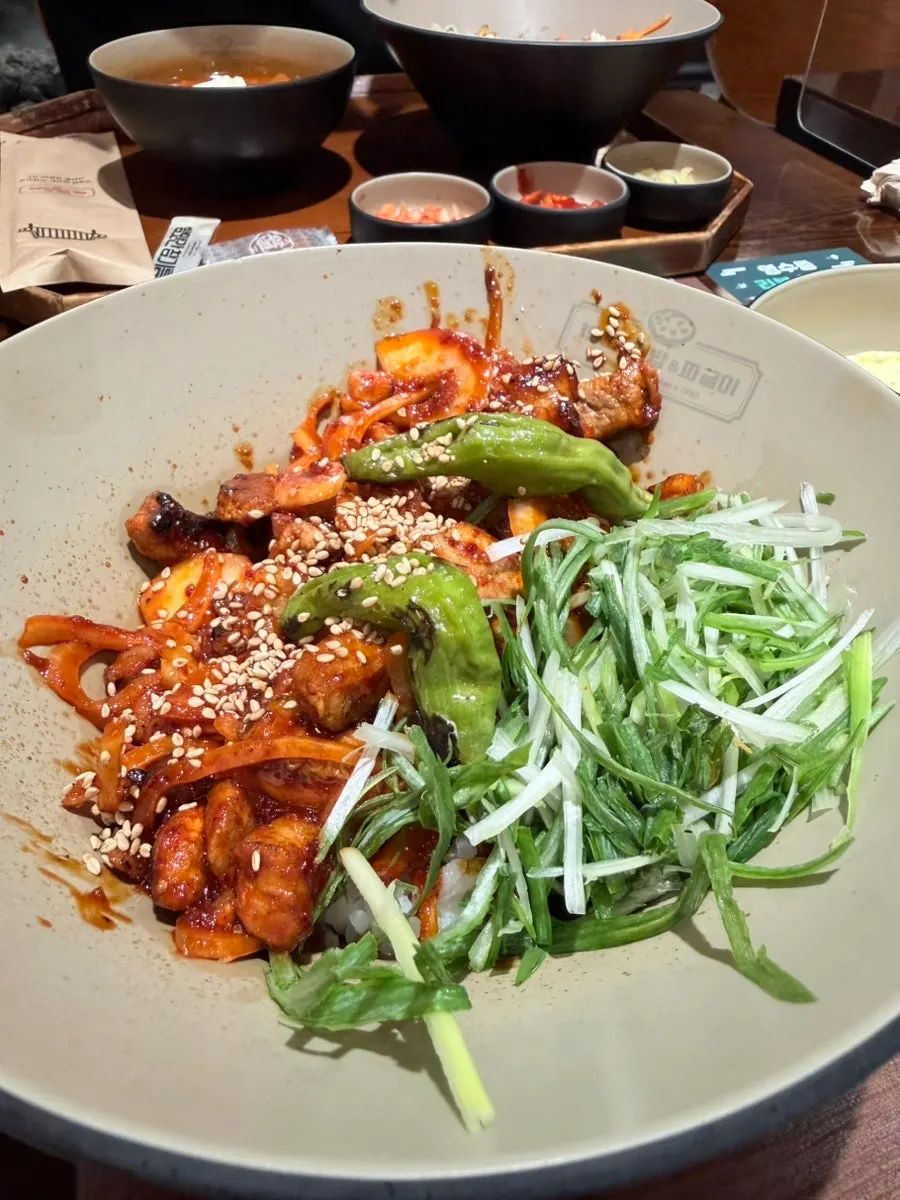 Jeolla-do style gochujang pork rice bowl topped with shredded scallions