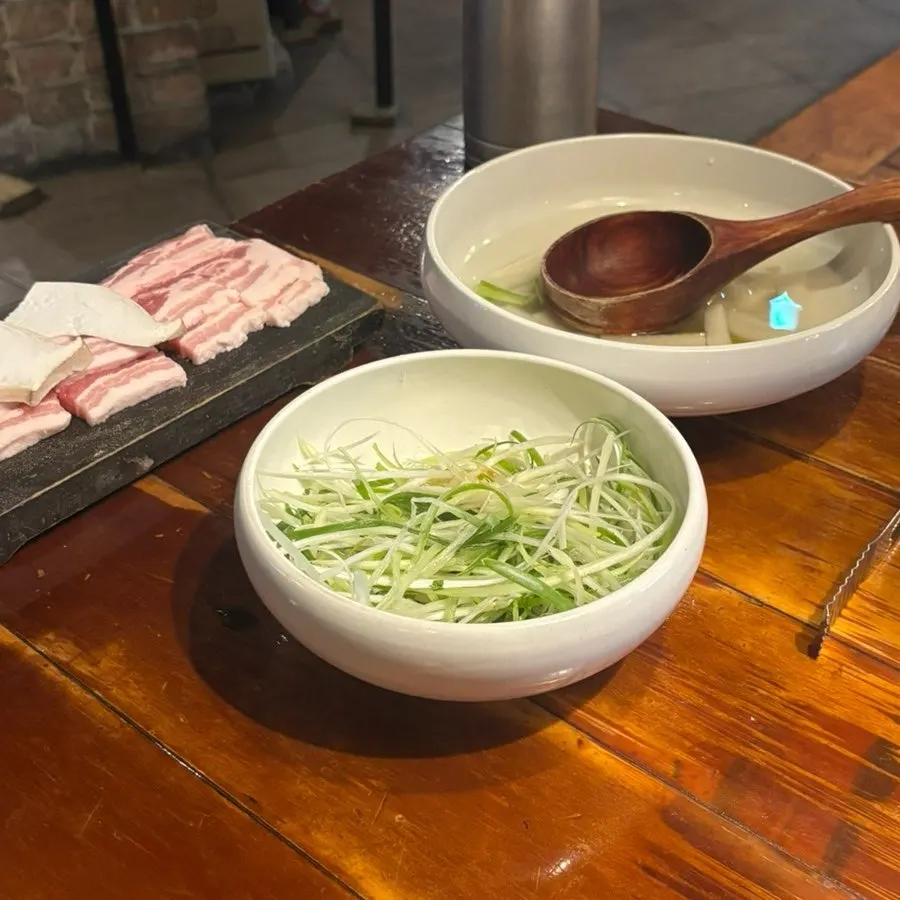 A full table of complimentary side dishes at Bongu Hwarro