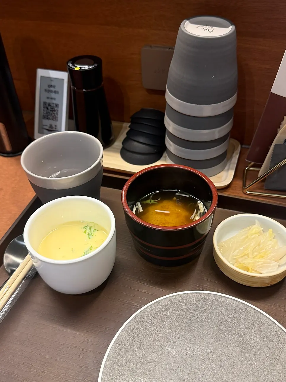 Miso soup and pickled ginger served first