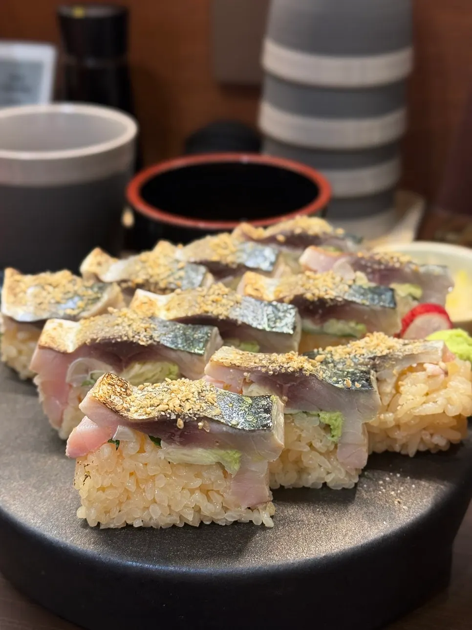 Saba bo sushi topped with a thick cut of mackerel