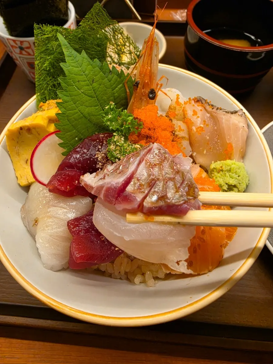 A bite of kaisendon wrapped in seaweed