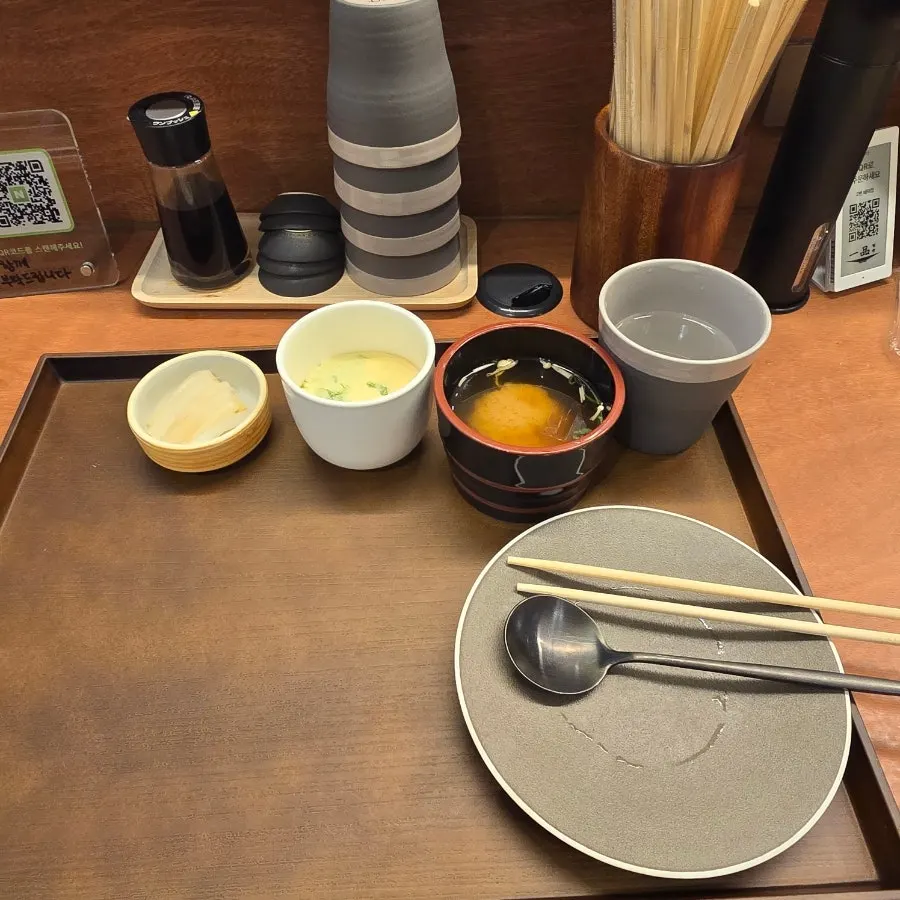 Clear broth and the personal water dispenser at the table