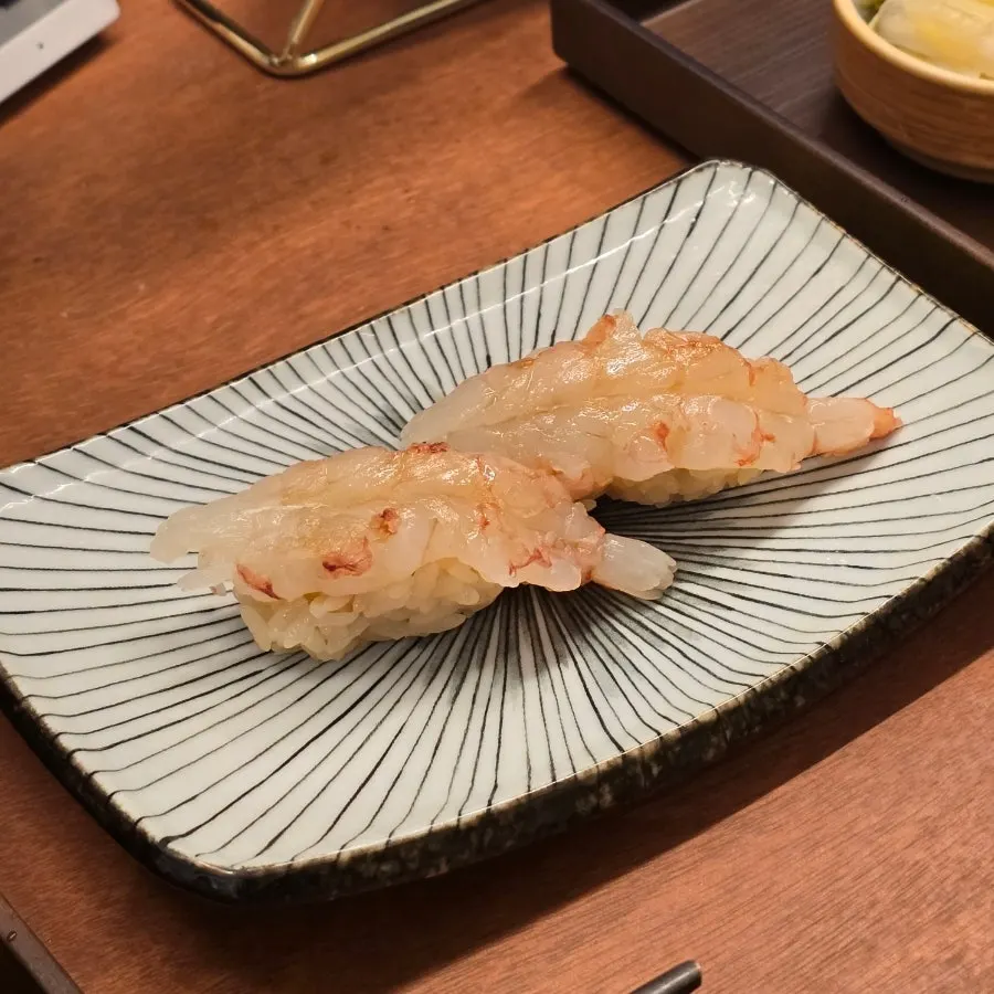 Two glossy pieces of hongsaeu sushi