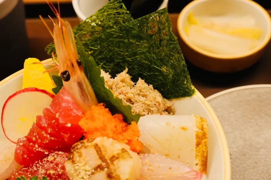 Close-up of kaisendon topped with salmon, tuna, and shrimp
