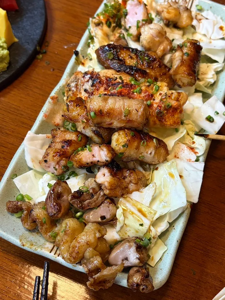 Yakitori served over cabbage