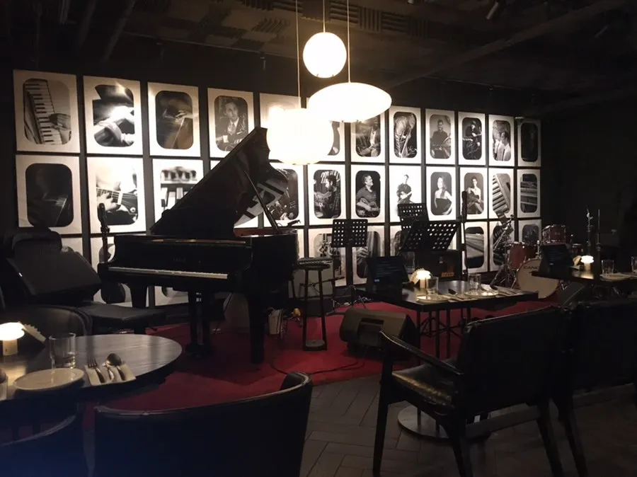 Interior of the jazz bar with bar tables and regular tables