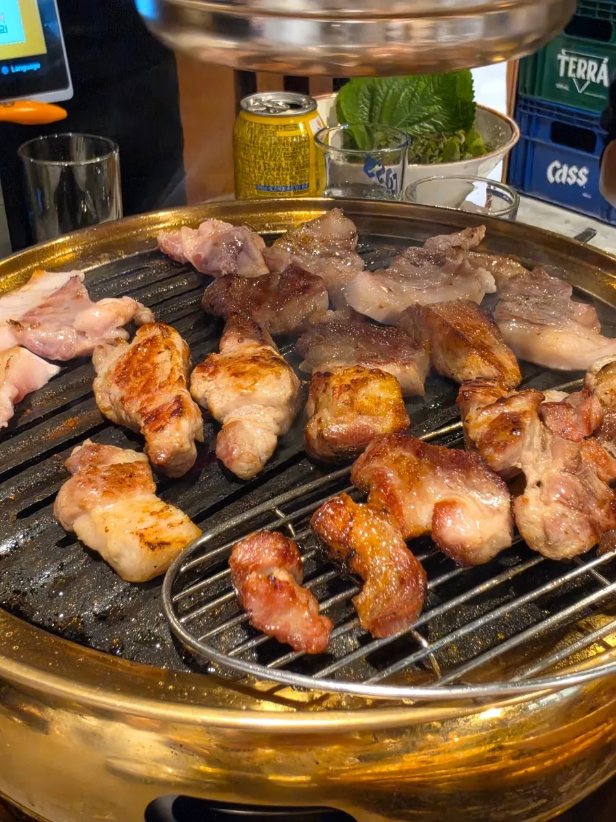 Aged whole pork belly and whole pork neck grilling on the pan