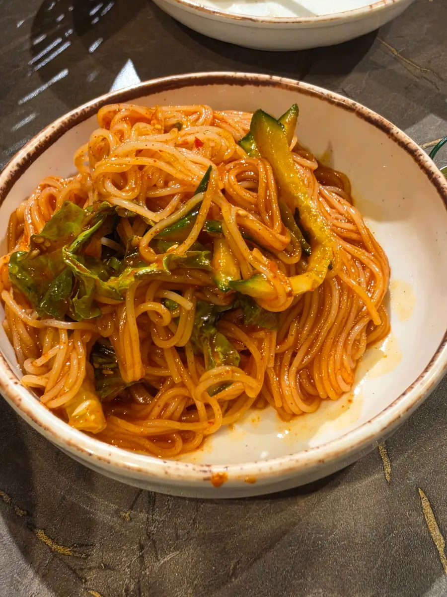 Kim Gwajang's bibim guksu topped with cucumber and vegetables