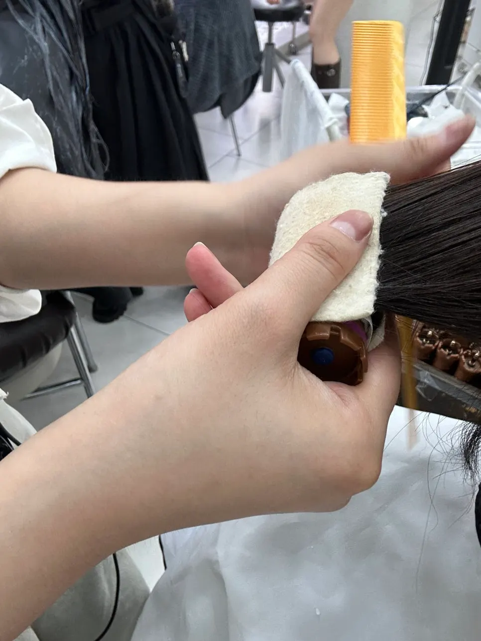 Applying perm solution mixed with an ampoule