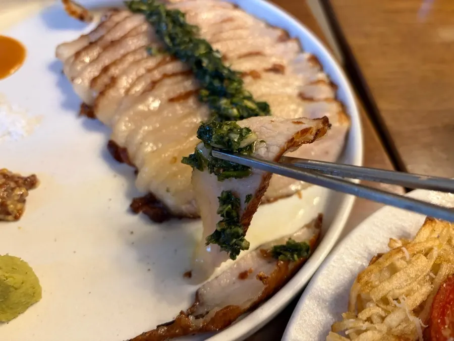 Chimichurri pork jowl topped with water parsley