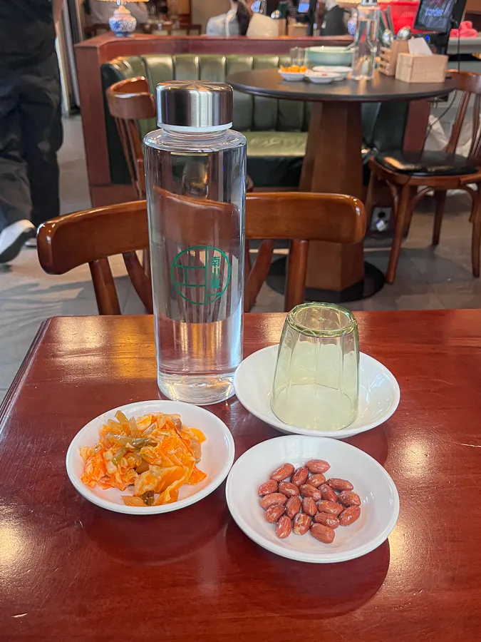Basic table setting of peanuts and water bottle