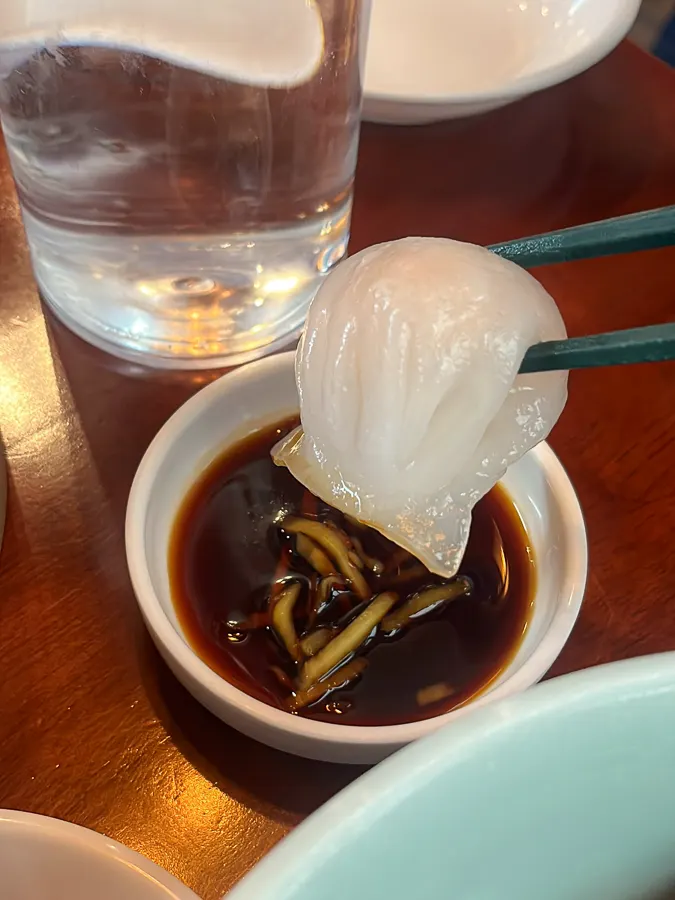 Har gow dim sum dipped in soy sauce