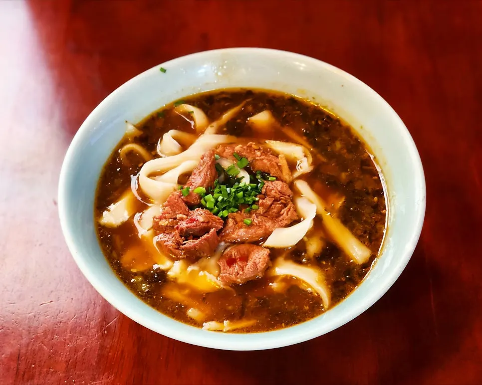 A bowl of Namsogwan's u yuk dosakmyeon topped with beef shank