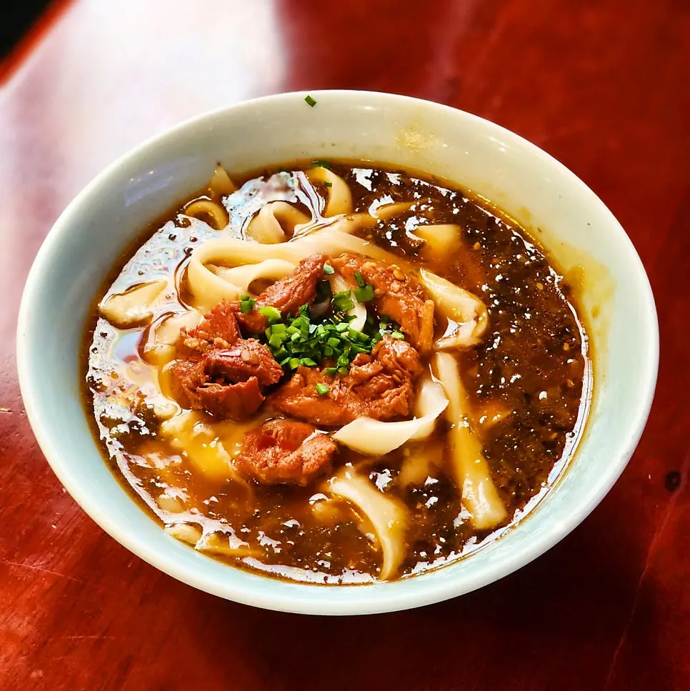 Close-up of dosakmyeon noodles soaked in broth