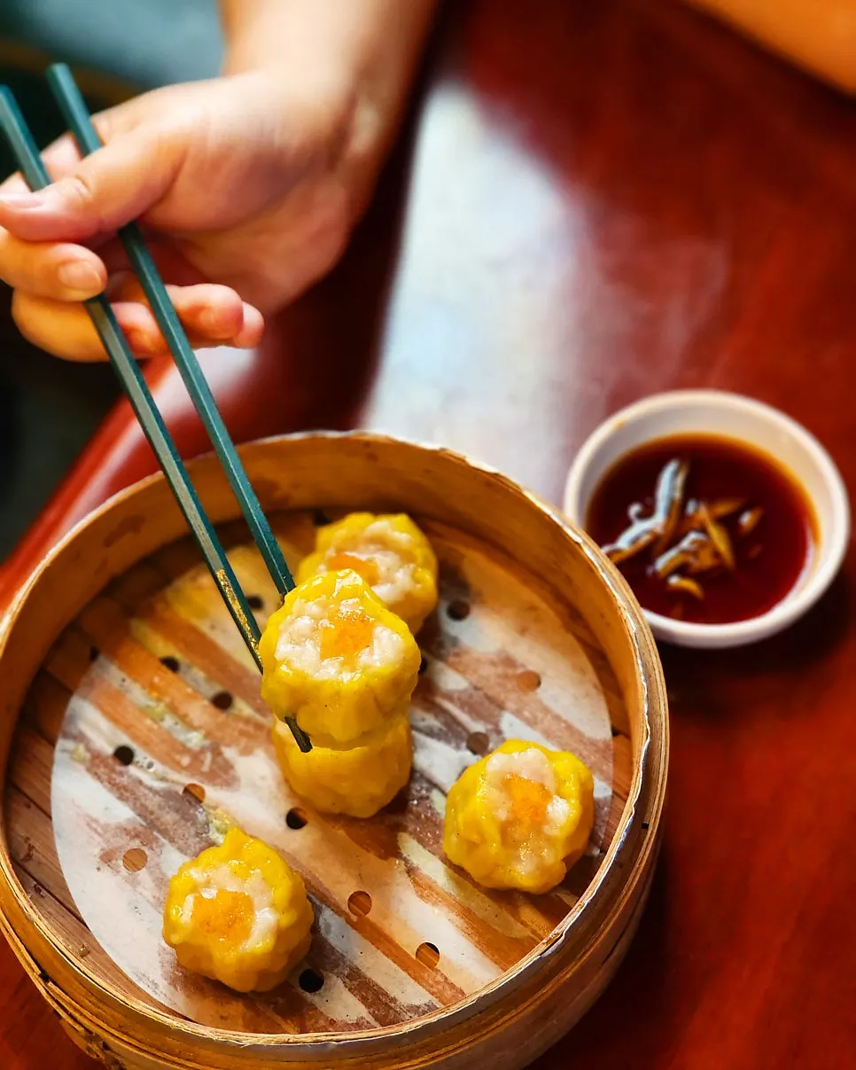 Shaomai dipped in special soy sauce